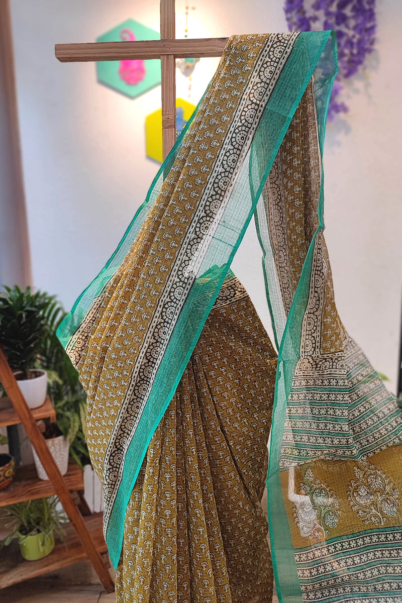 Handblock Printed Kota Doria Saree – Mustard with Green Border & Floral Motifs