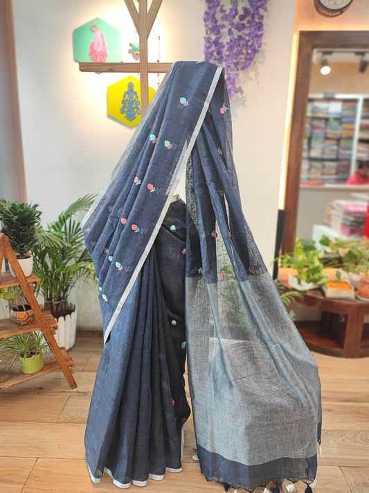 Navy Blue Pure Linen Saree with Multicolor Floral Embroidery, Silver Border & Checkered Pallu – Everyday Elegance with White-Black Tassels