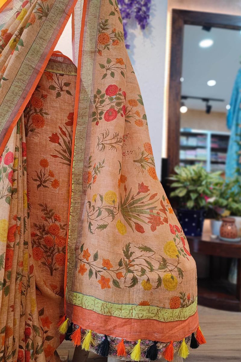 Beige Floral Printed Linen Cotton Saree with Orange Border & Multicolor Tassels
