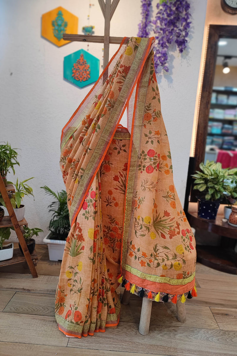 Beige Floral Printed Linen Cotton Saree with Orange Border & Multicolor Tassels